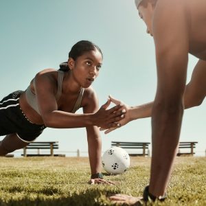 Fitness partner, exercise and sport training with couple workout in a park doing pushup for wellnes